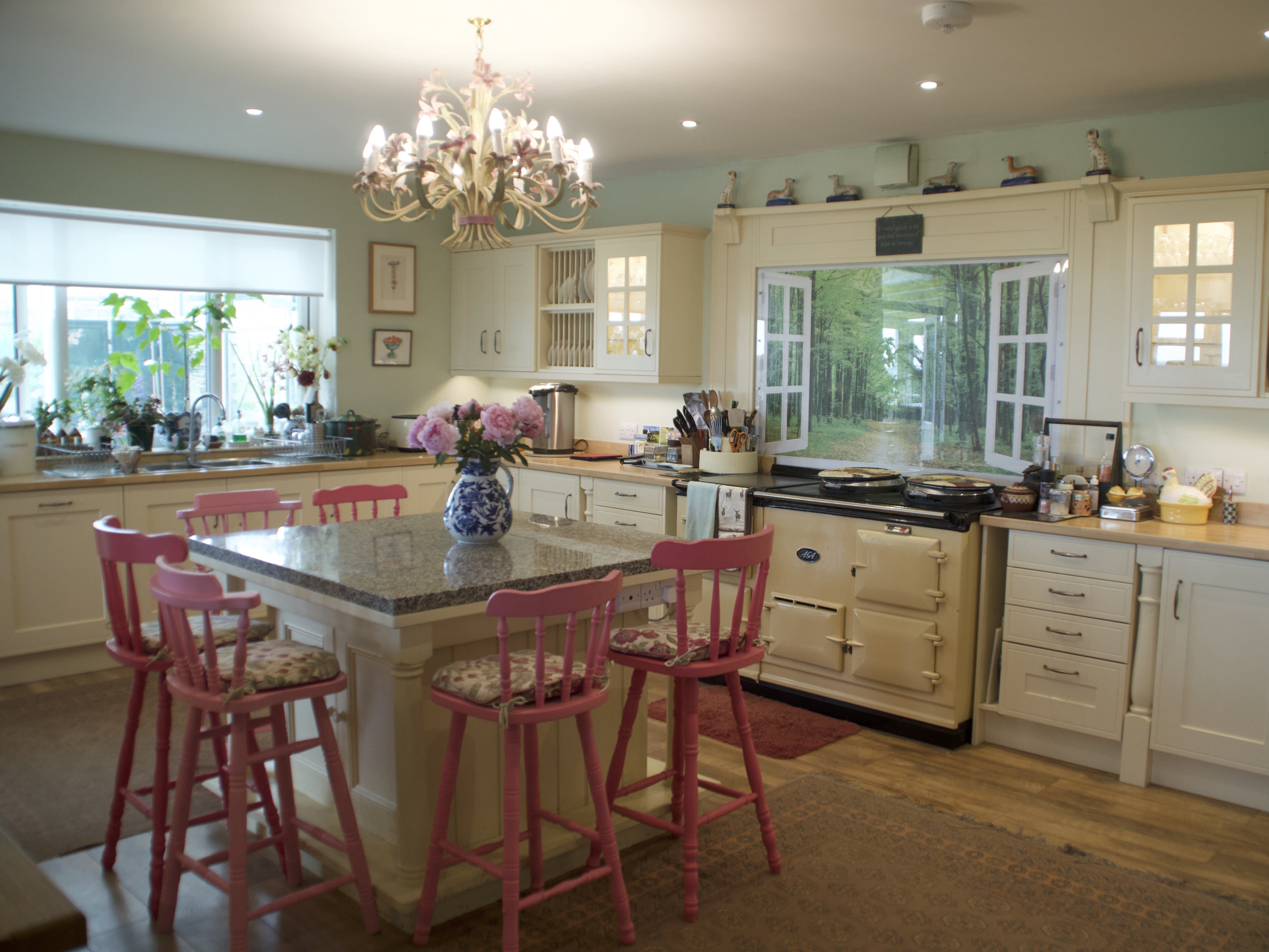 Large kitchen with an island for seating, moorland landscape in the background